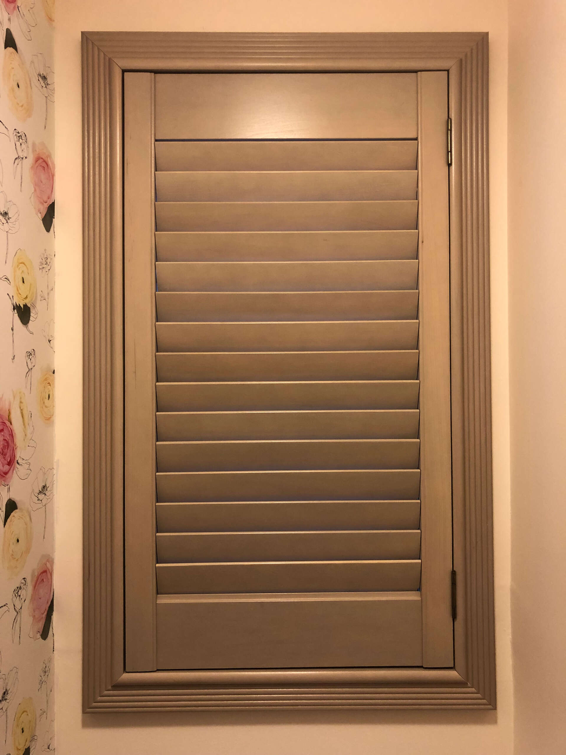 Close up of brown interior shutter installed in home